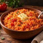 Tomato and butter rice with a pat of butter in a bowl